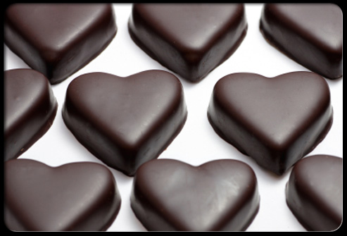 a box of chocolate hearts on a white surface