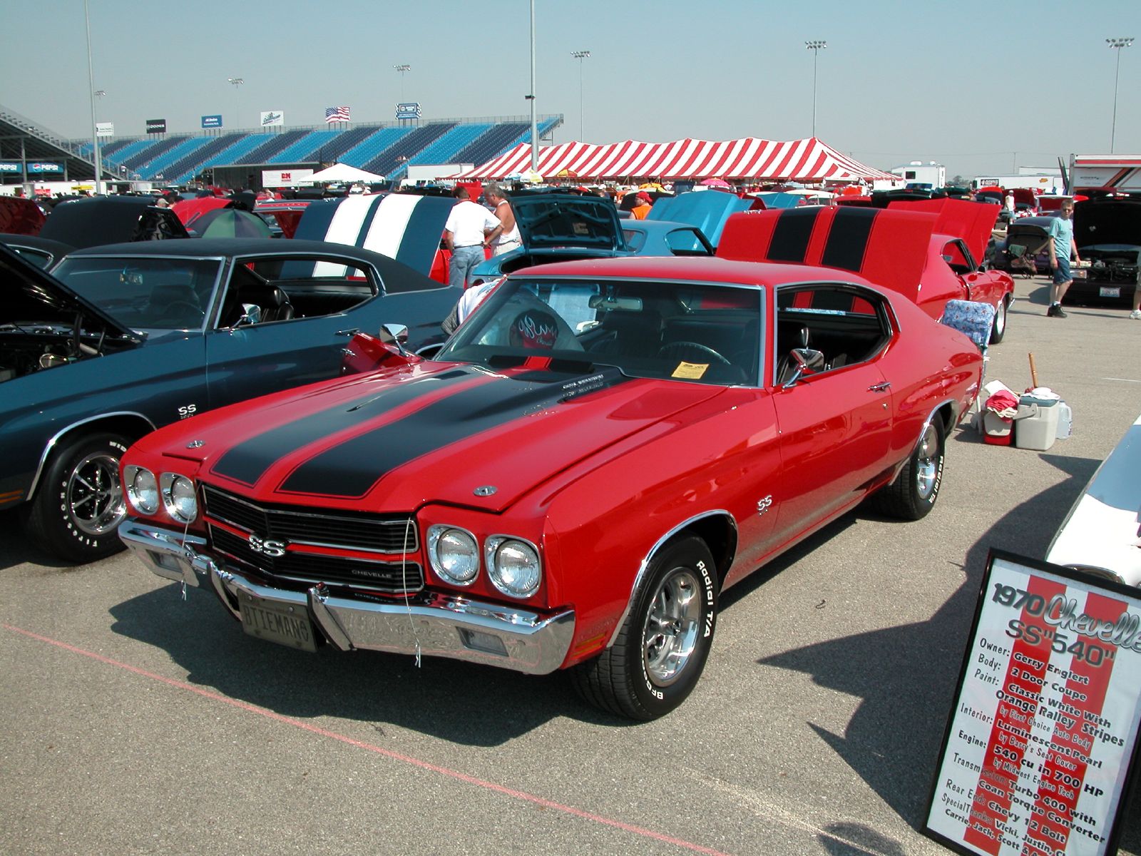 the mustang is among other muscle cars at the car show