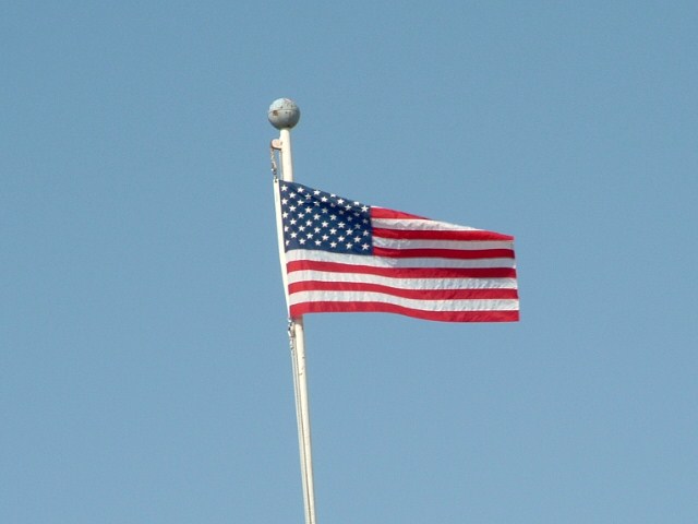 a flag is flying on the top of a hill