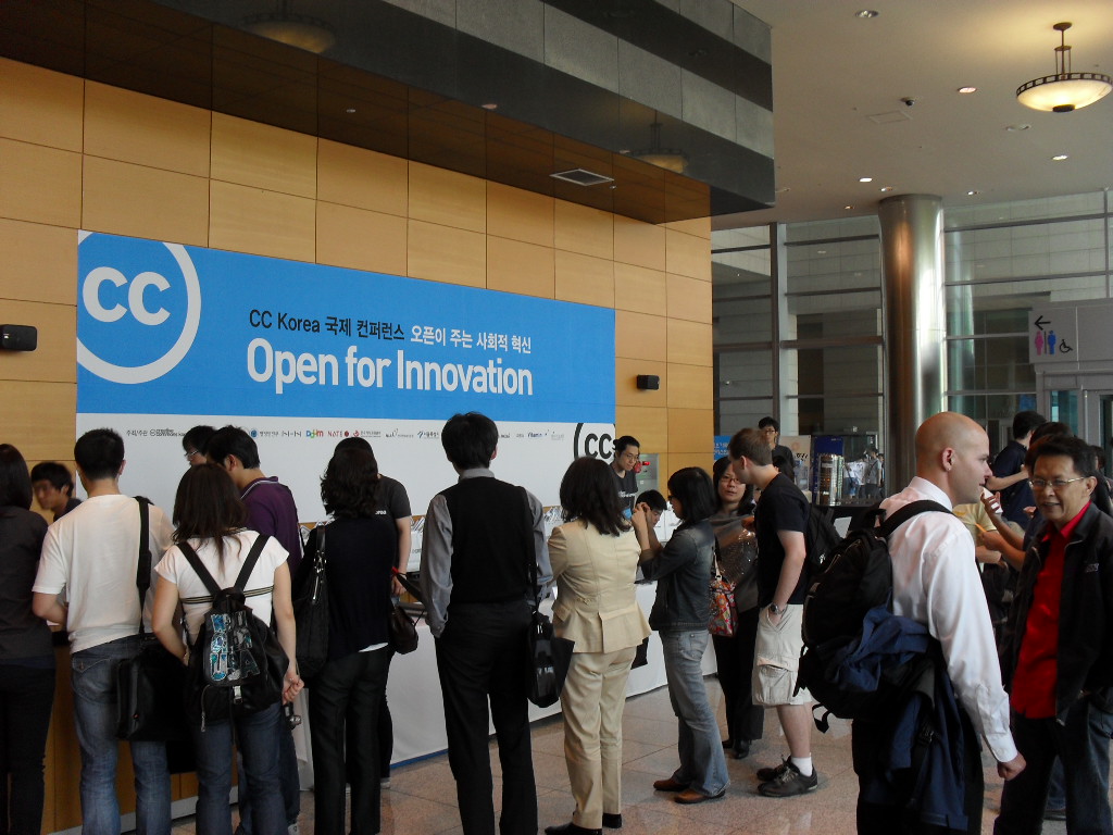 people standing in line to see an open for innovation sign