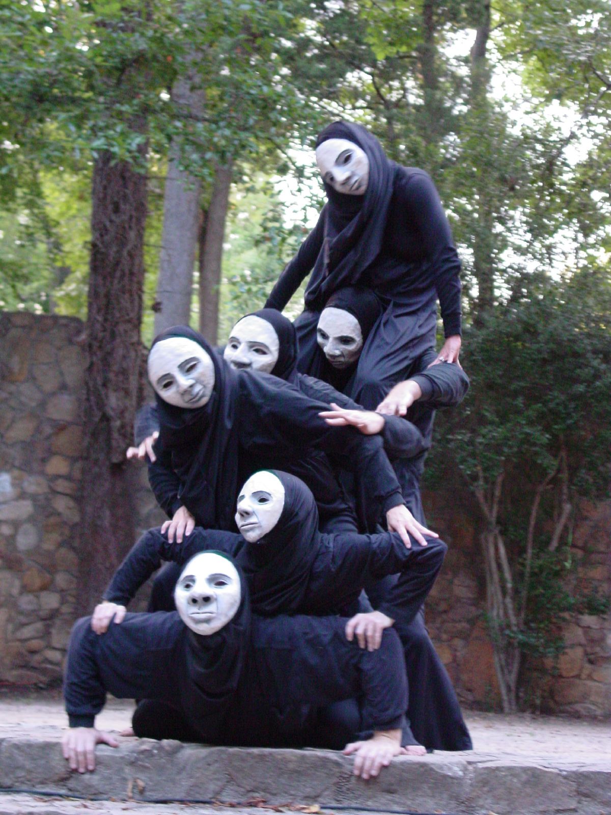 a group of people with white masks standing around