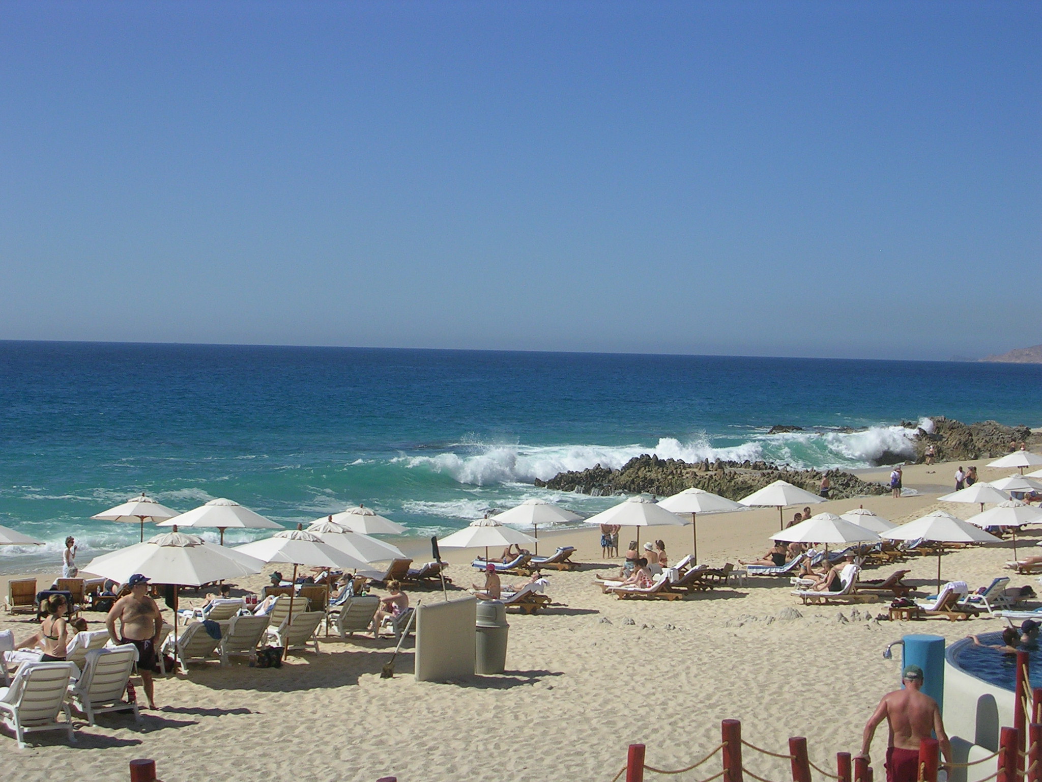 several umbrellas and chairs set up on the beach