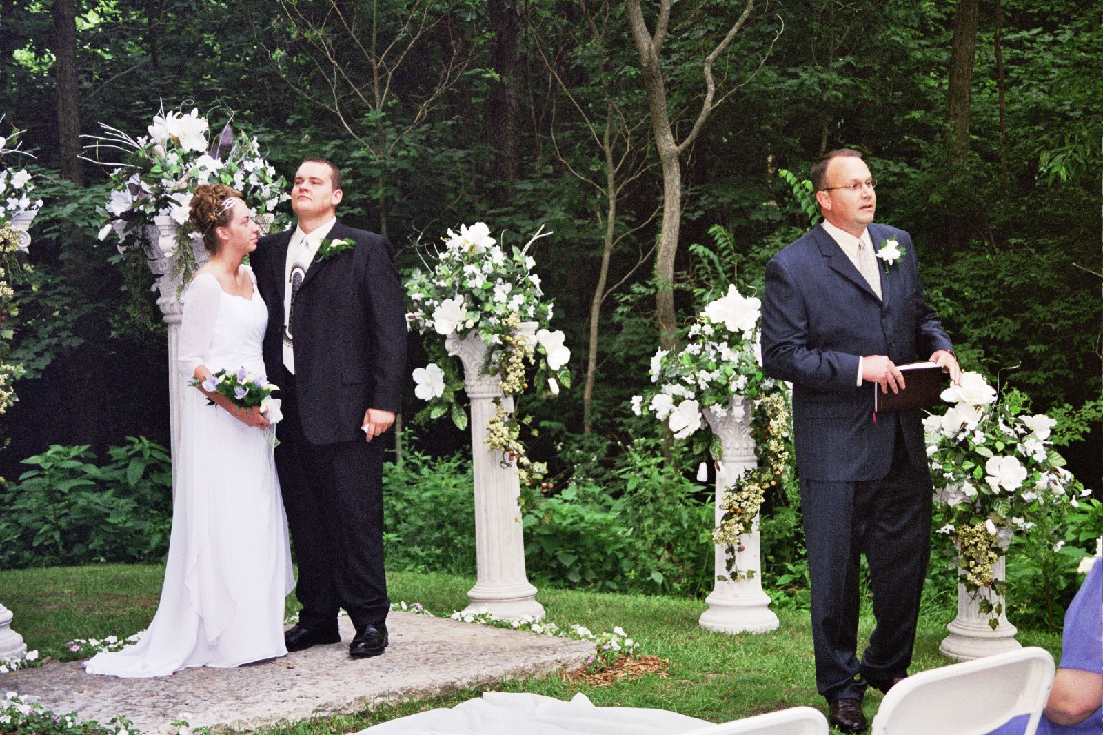 a couple kissing in front of their wedding guests