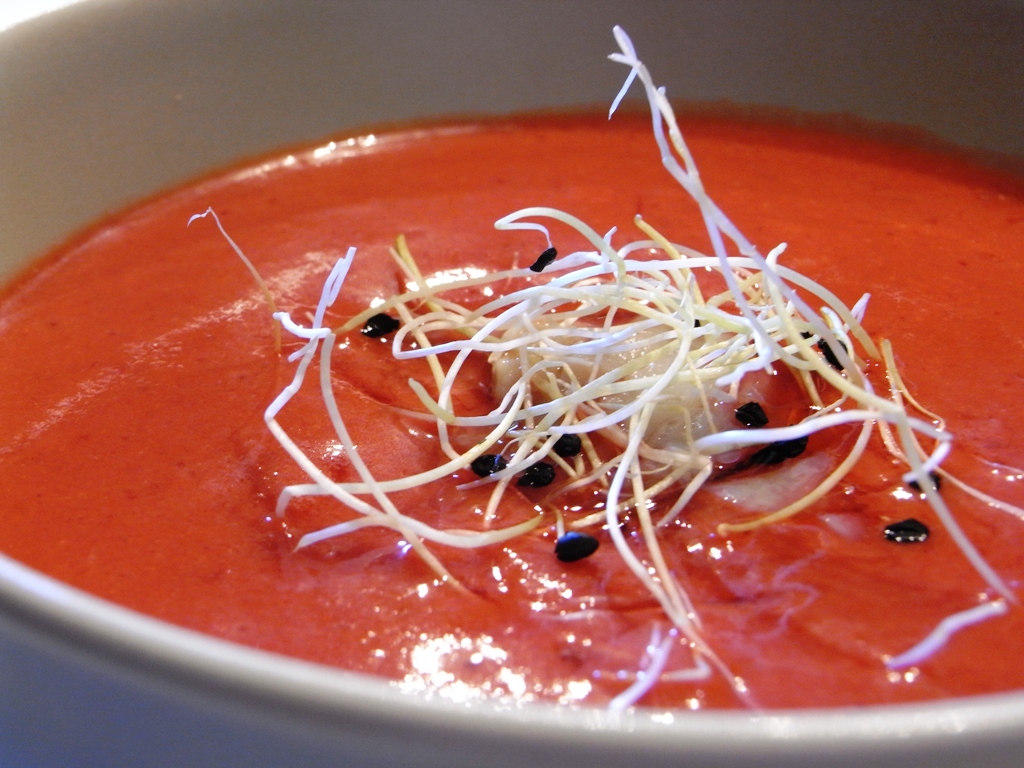 the bowl is filled with red and white soup