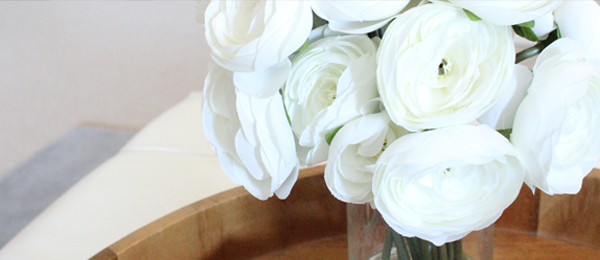 a bunch of white flowers sitting in a glass vase