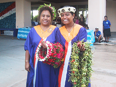 two women dressed in dress and with a wreath