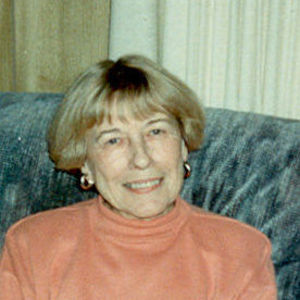 a woman in pink sweater sitting on the couch