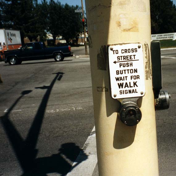 a street sign posted on a telephone pole with another sign attached to it