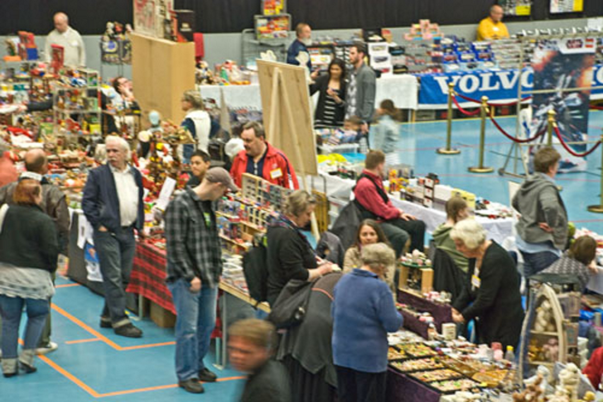 a big crowded room filled with people at an exhibition