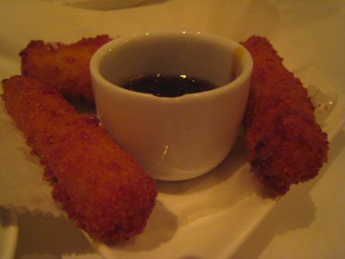 a meal consisting of fish sticks, sauce and breadcrumbs