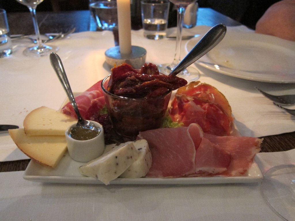 a fancy plate full of meat and cheese