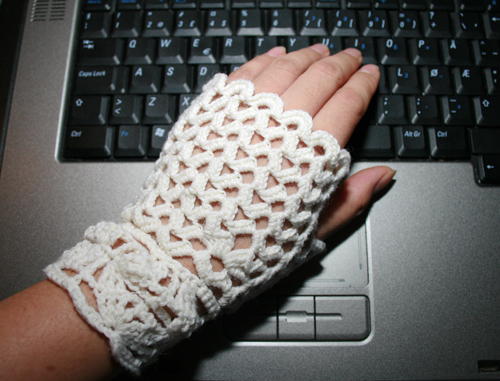 a woman is holding her hand near a laptop