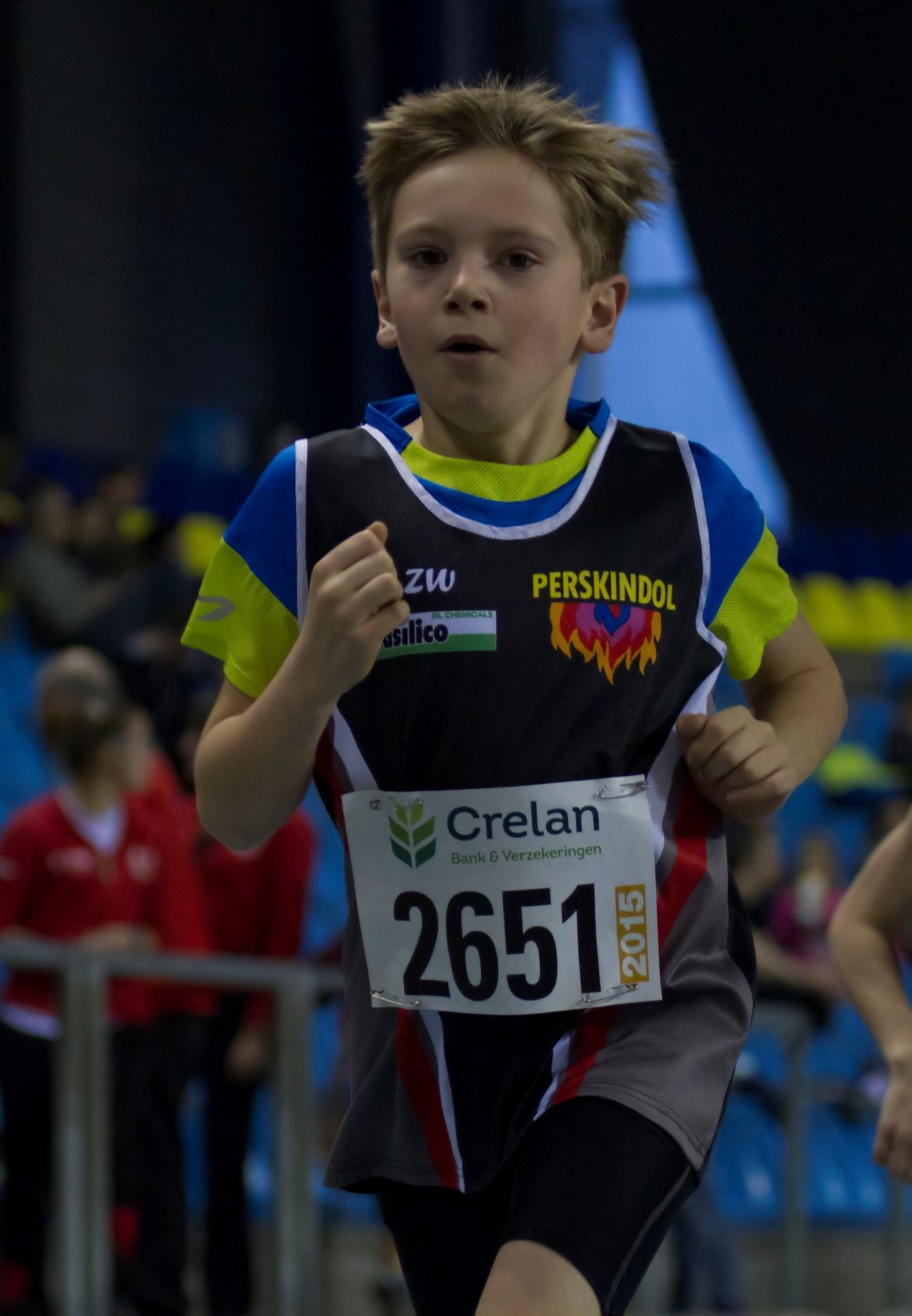 a boy in shorts runs during an event