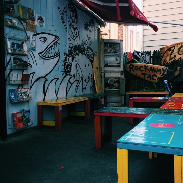 a colorful table set up outside next to a store front