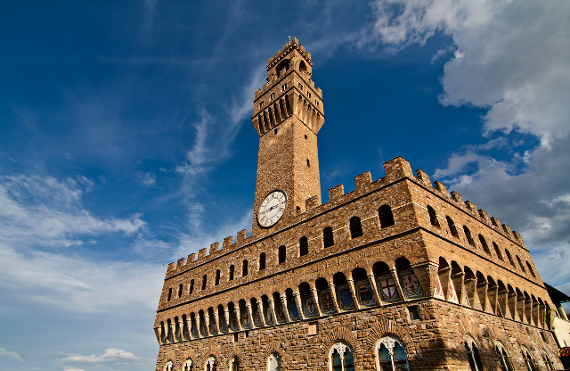 a large brick tower with a clock sitting on it's side