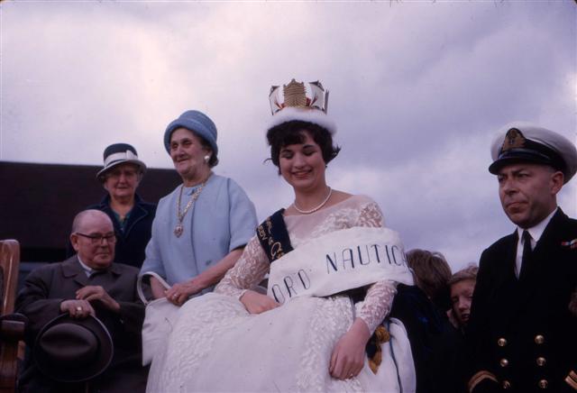 a group of people in formal wear posing for a po