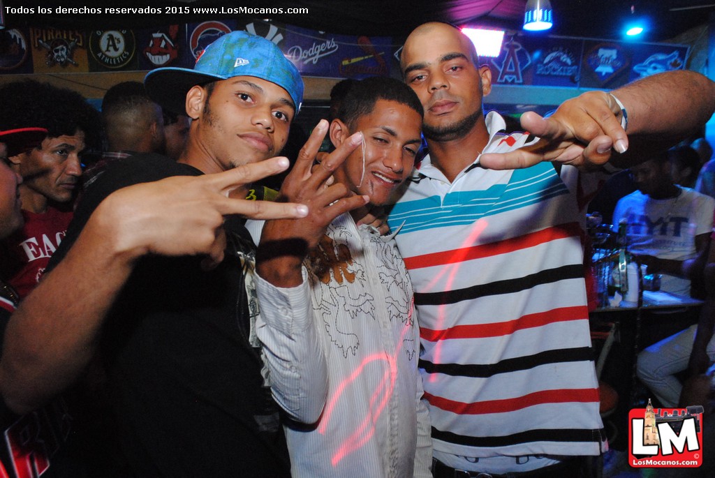 several men pose together at a club