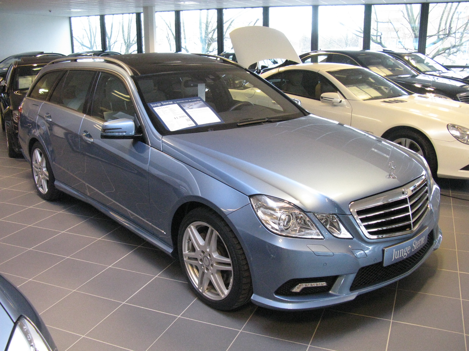 a silver car is sitting on display in a showroom