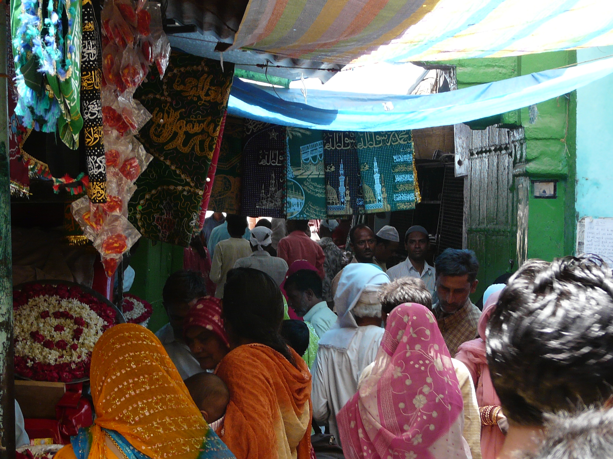 people stand around a market with souvenirs