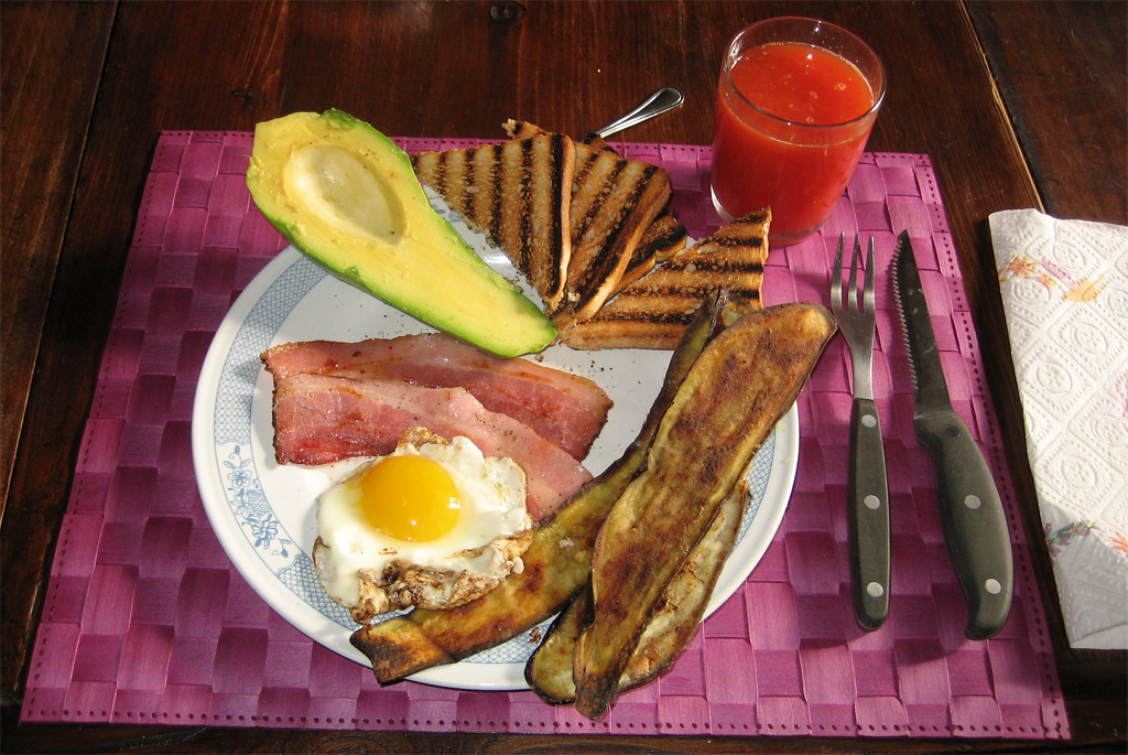 a plate with eggs, toast, and bacon