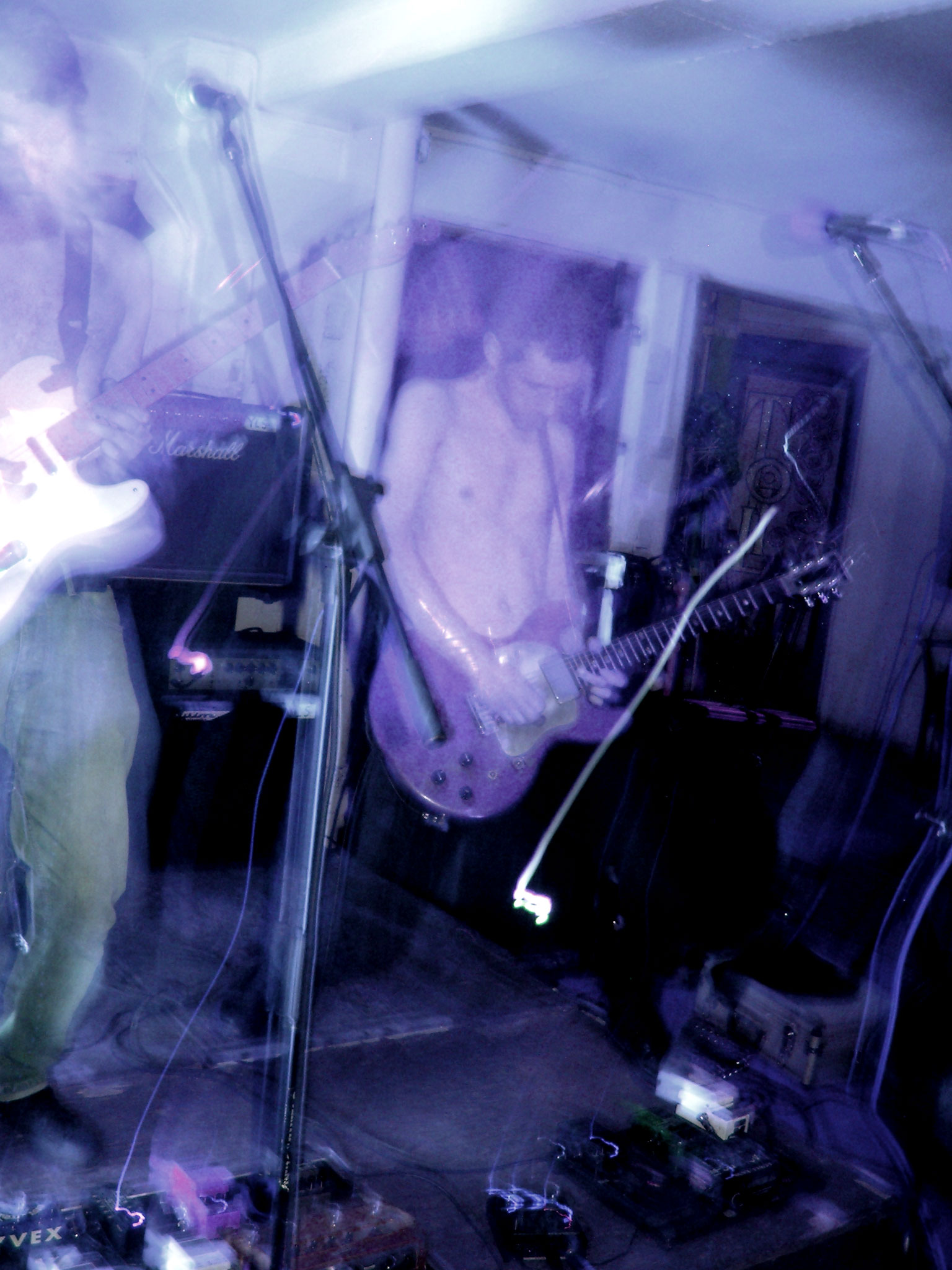 a man playing guitar in the middle of a room