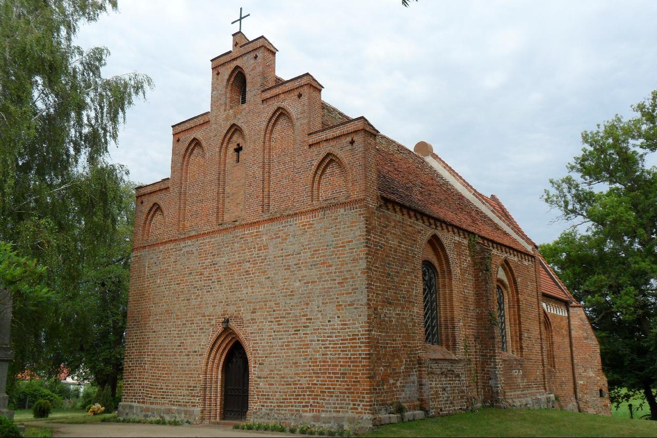 the church is very tall and red brick