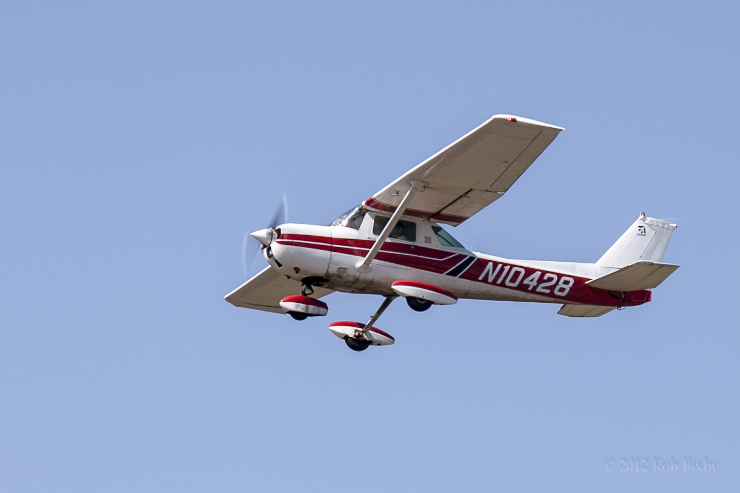 an airplane flying high in the sky with a propeller on top