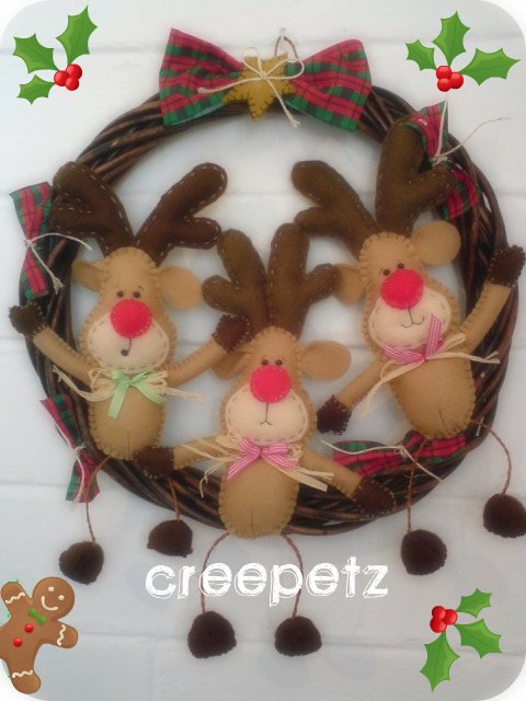 a po of three little reindeers on christmas wreath