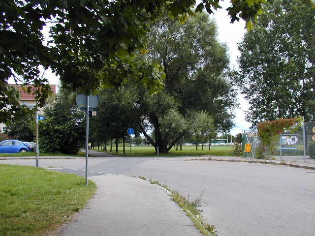 an empty, quiet urban street with traffic and trees