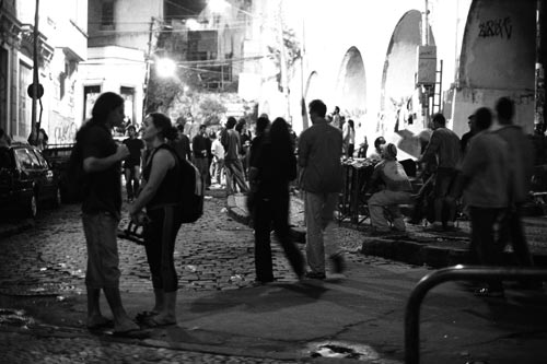 people gather in the street at night with their bikes