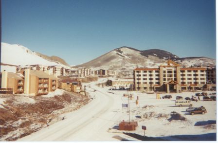 a snow covered mountain with buildings and a road