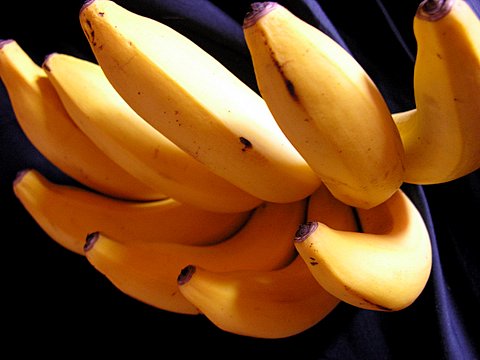 a bunch of ripe bananas on a black table