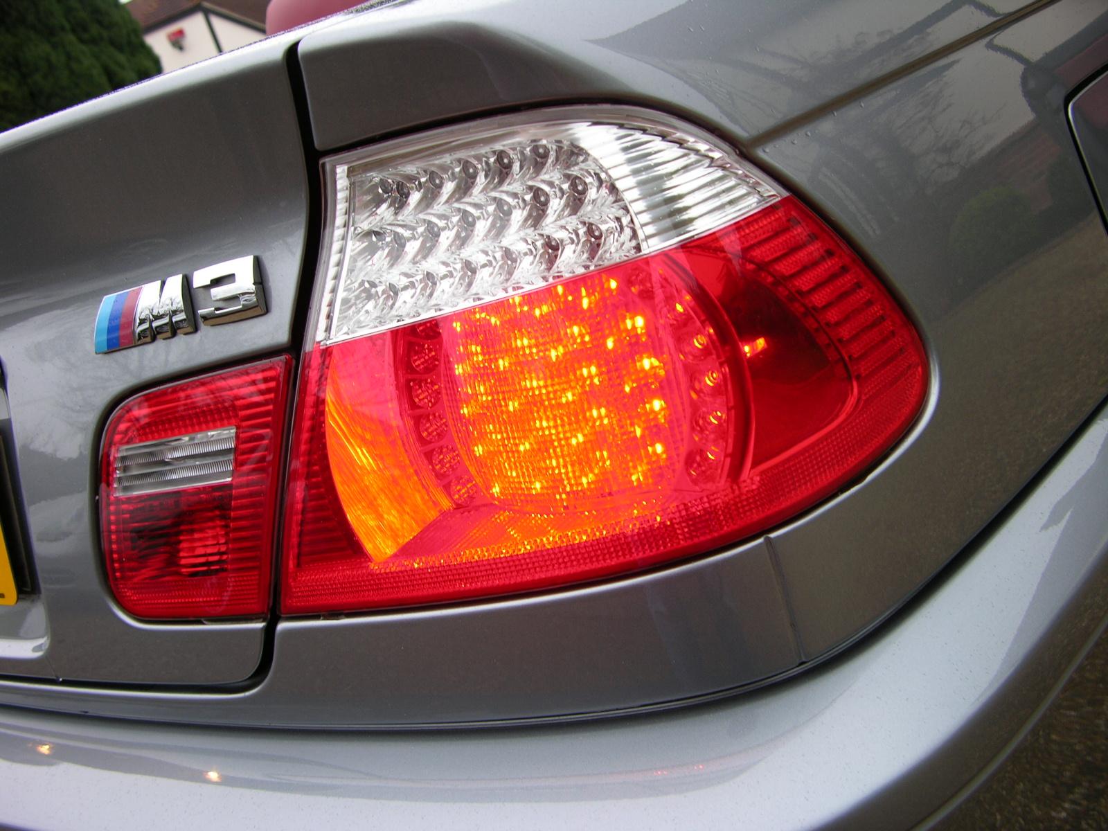 a close up of the tail lights of a grey car