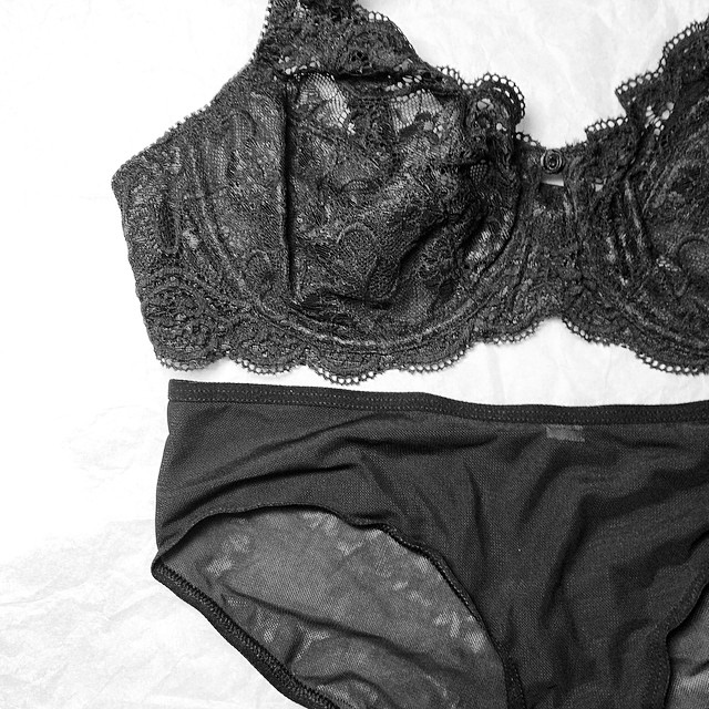 a black  and a panties lying on the bed