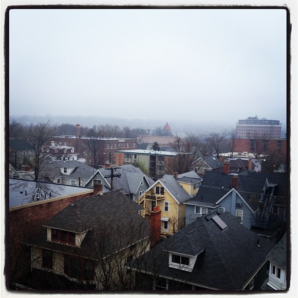 foggy cityscape with rooftops and residential buildings