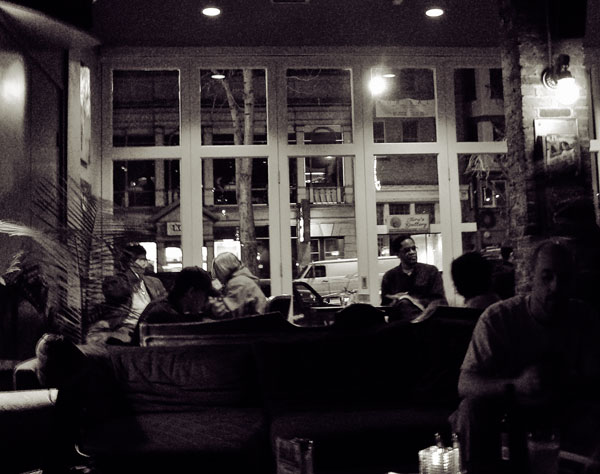 a black and white po of a group of people in a bar