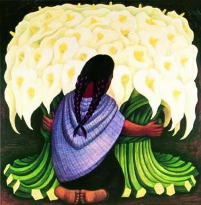 a woman sits on her knees next to white flowers