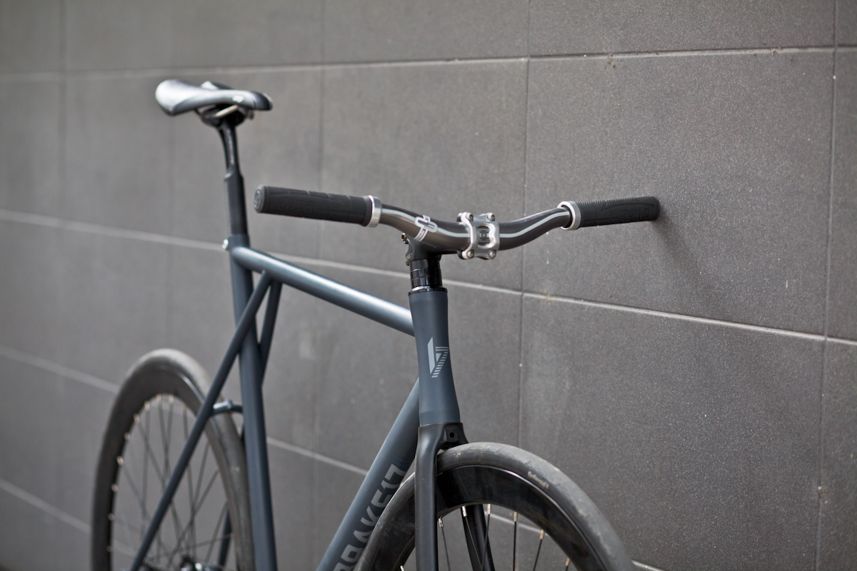 a bicycle leans against a concrete wall