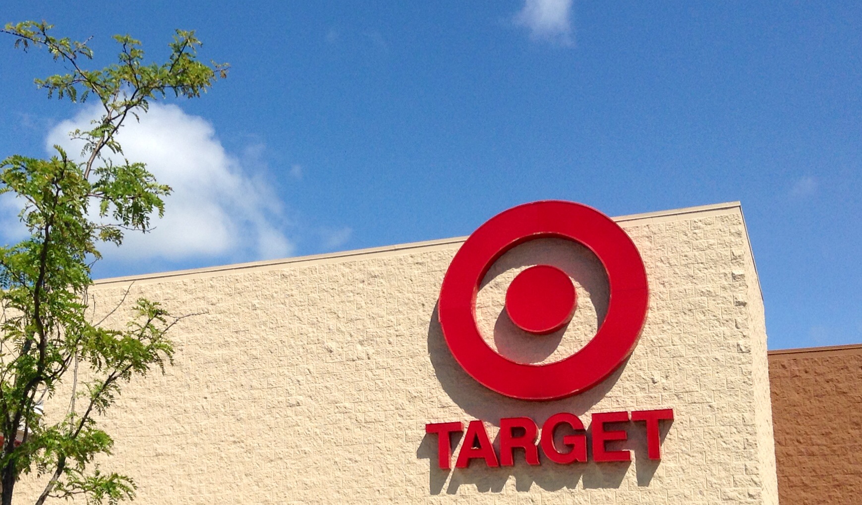 a large target sign next to a building on a clear day