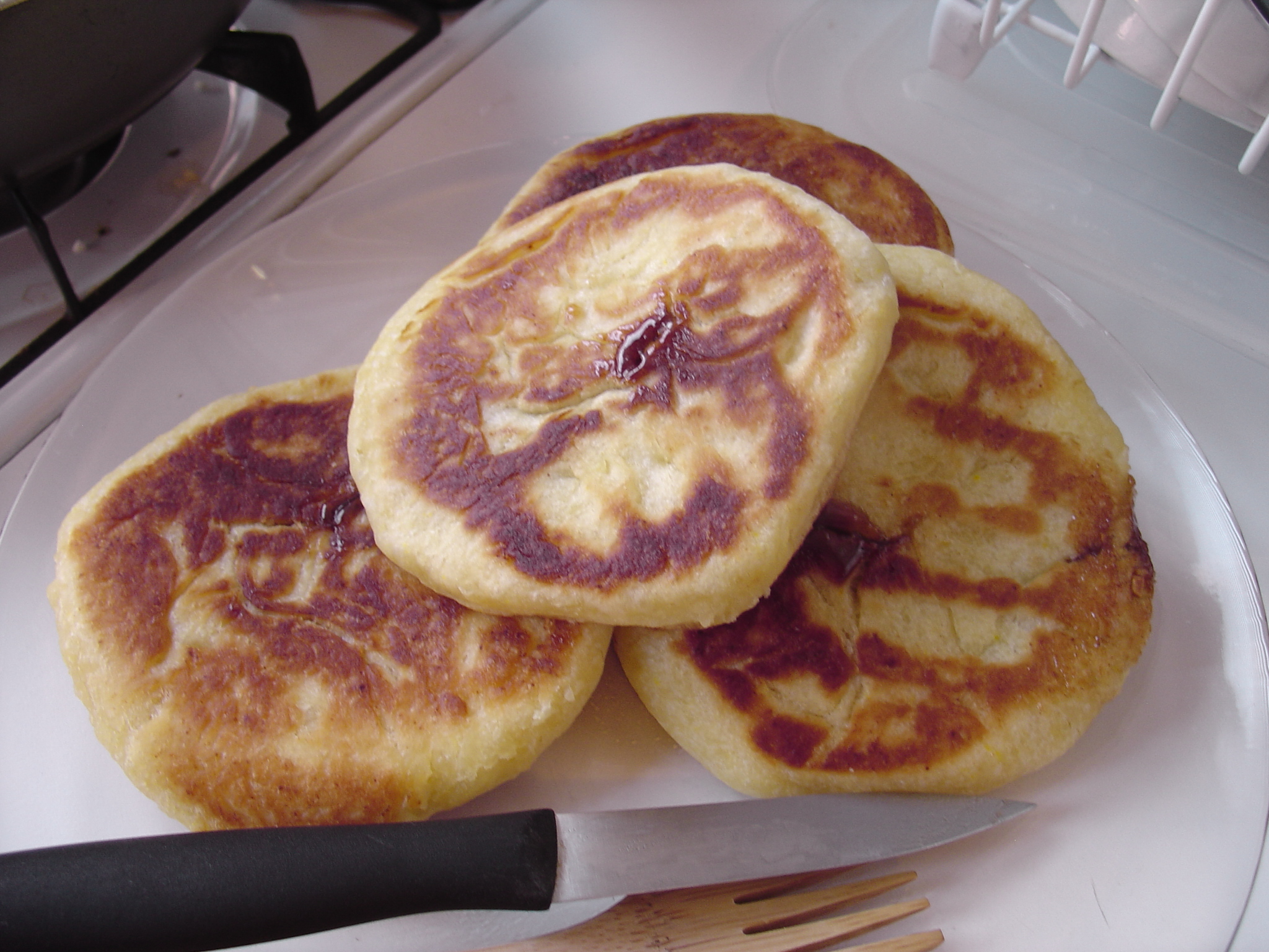 a stack of pancakes with decorative design is on the plate