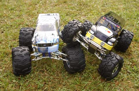 a toy truck and four large wheeled monster trucks
