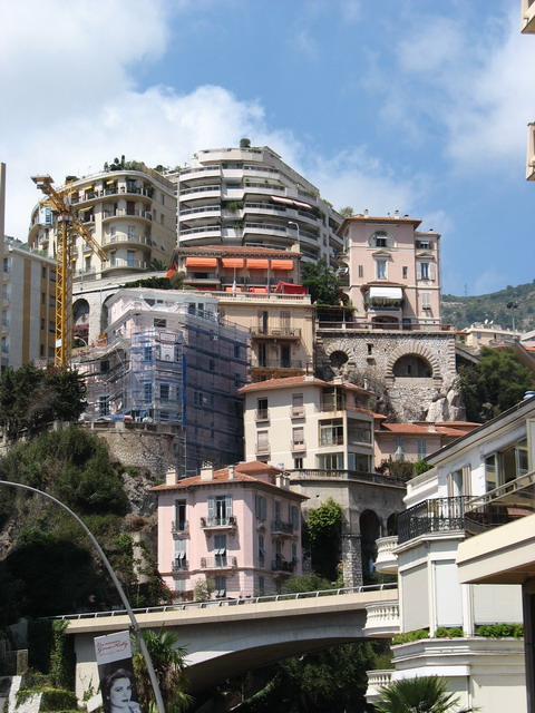 an image of a hill side city with buildings