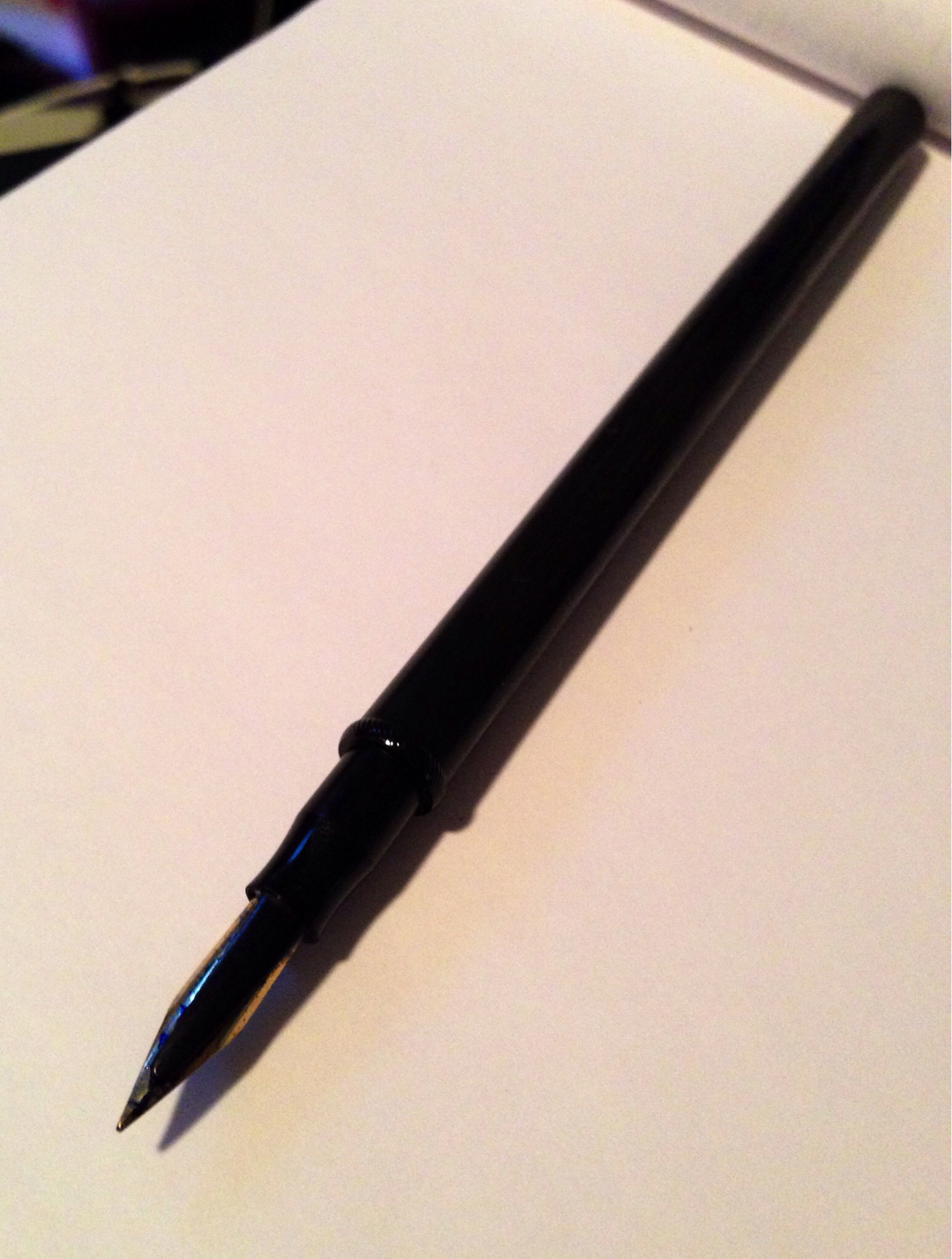a pen sits on top of a note pad