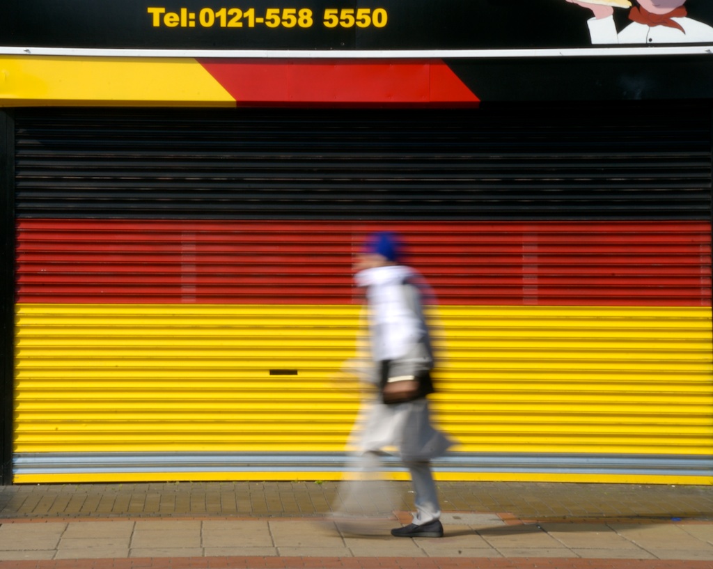 a man walking along side of a closed shop