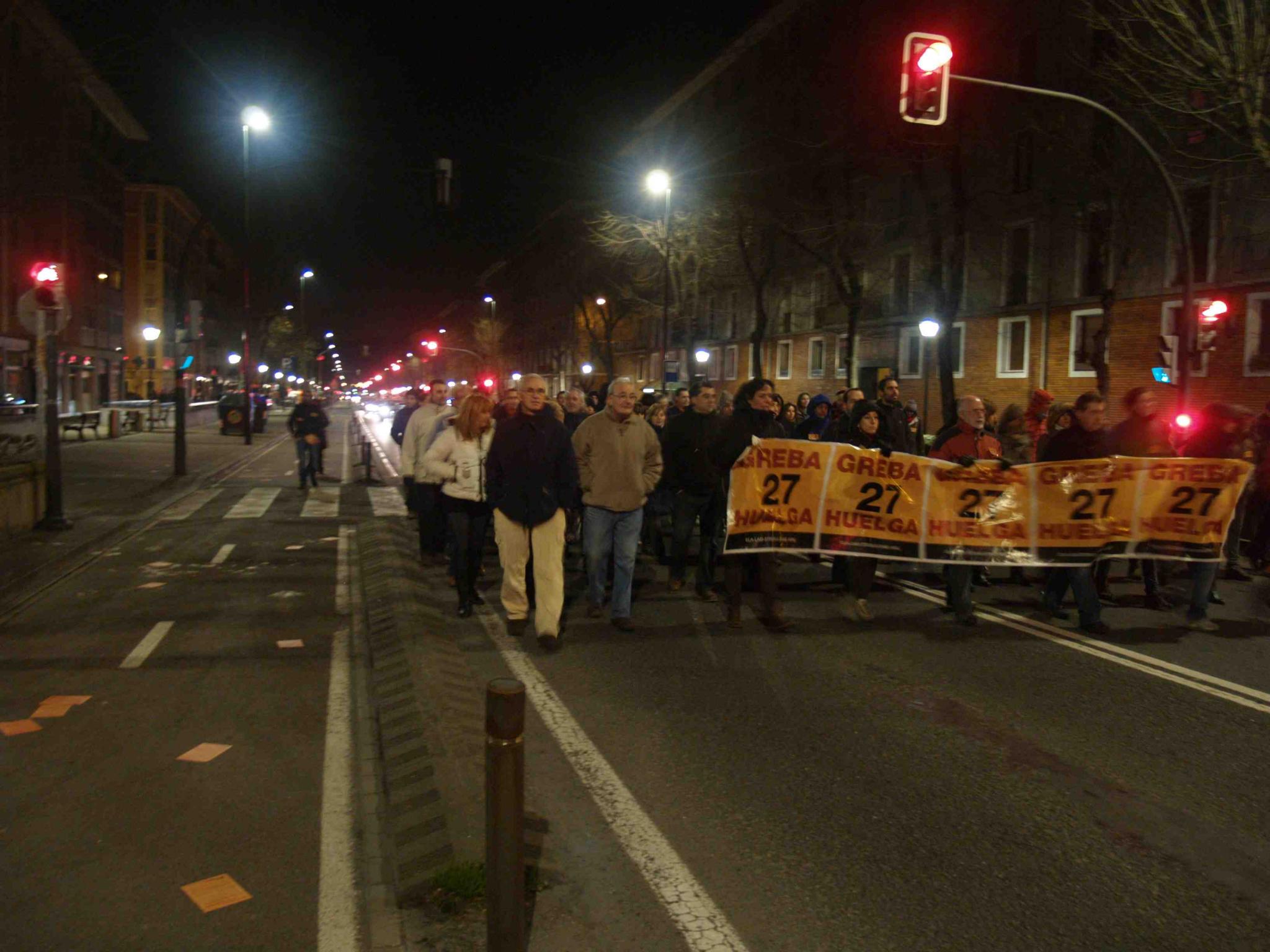 a group of people are standing behind the line of signs