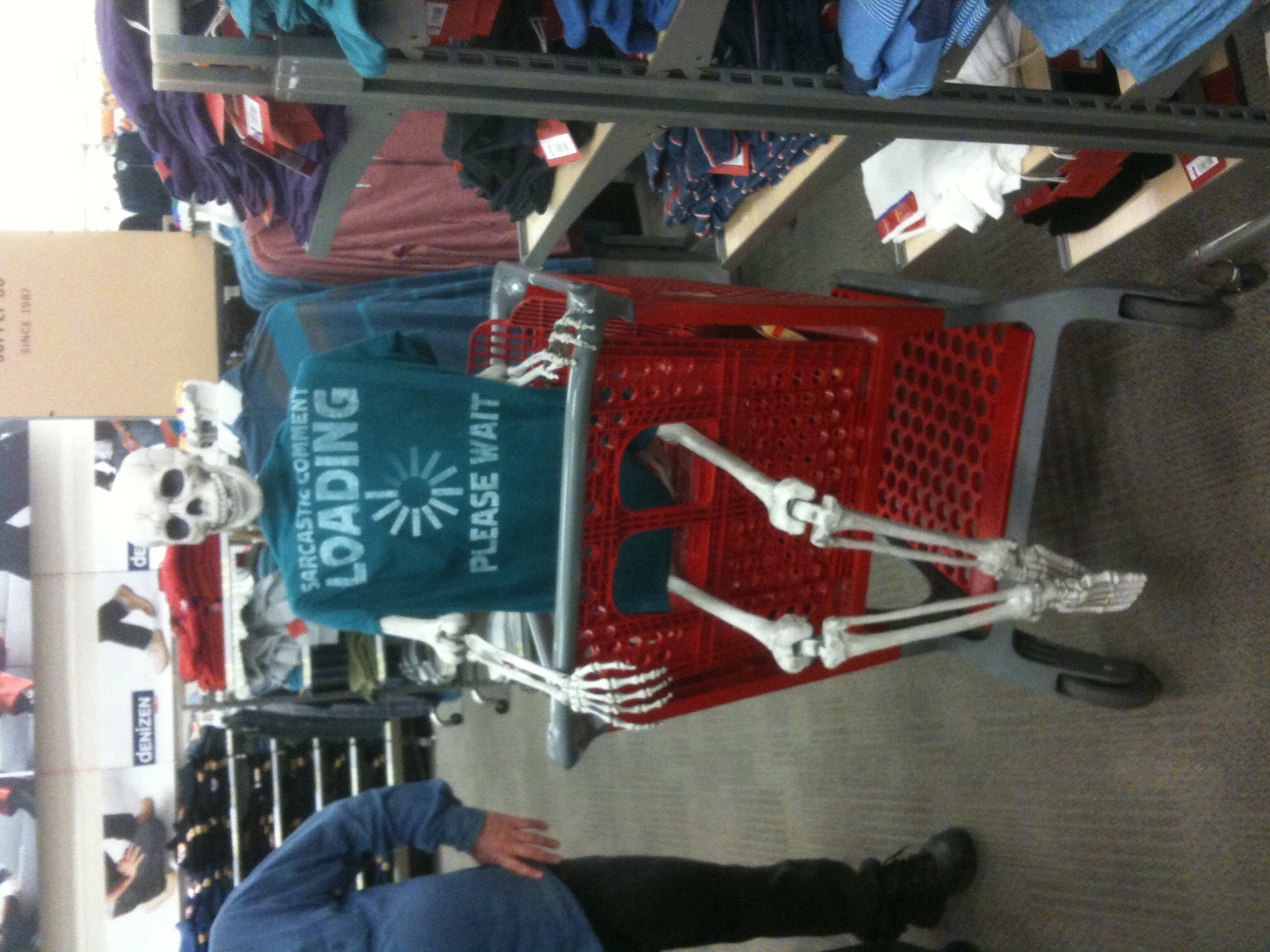 a skeleton sits in the middle of a grocery cart