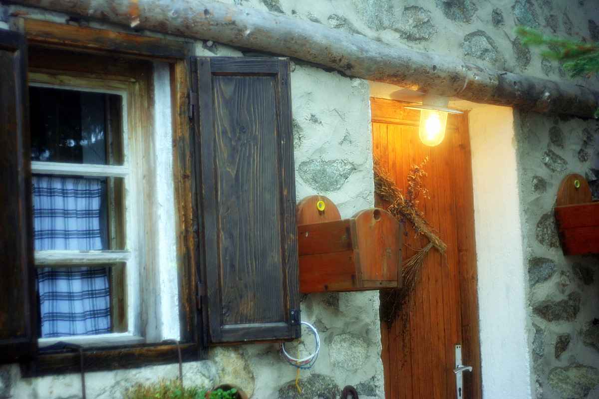 an entrance to a door and window area of an old house