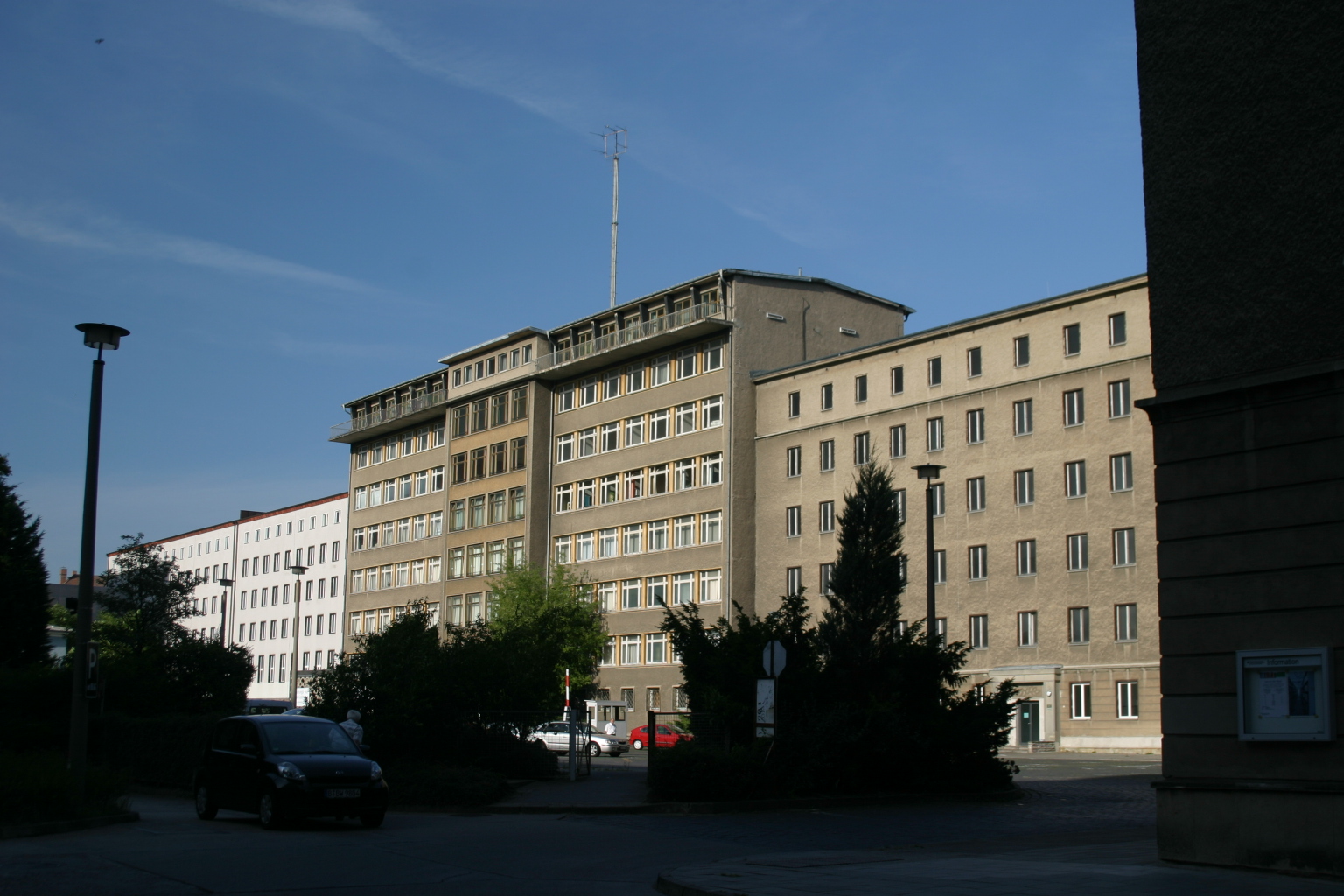 a building on a street next to trees