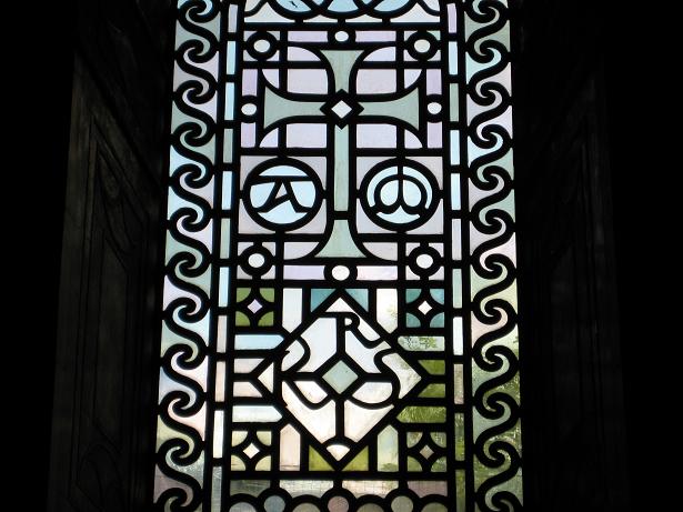 a large stained glass window with decorative designs on it