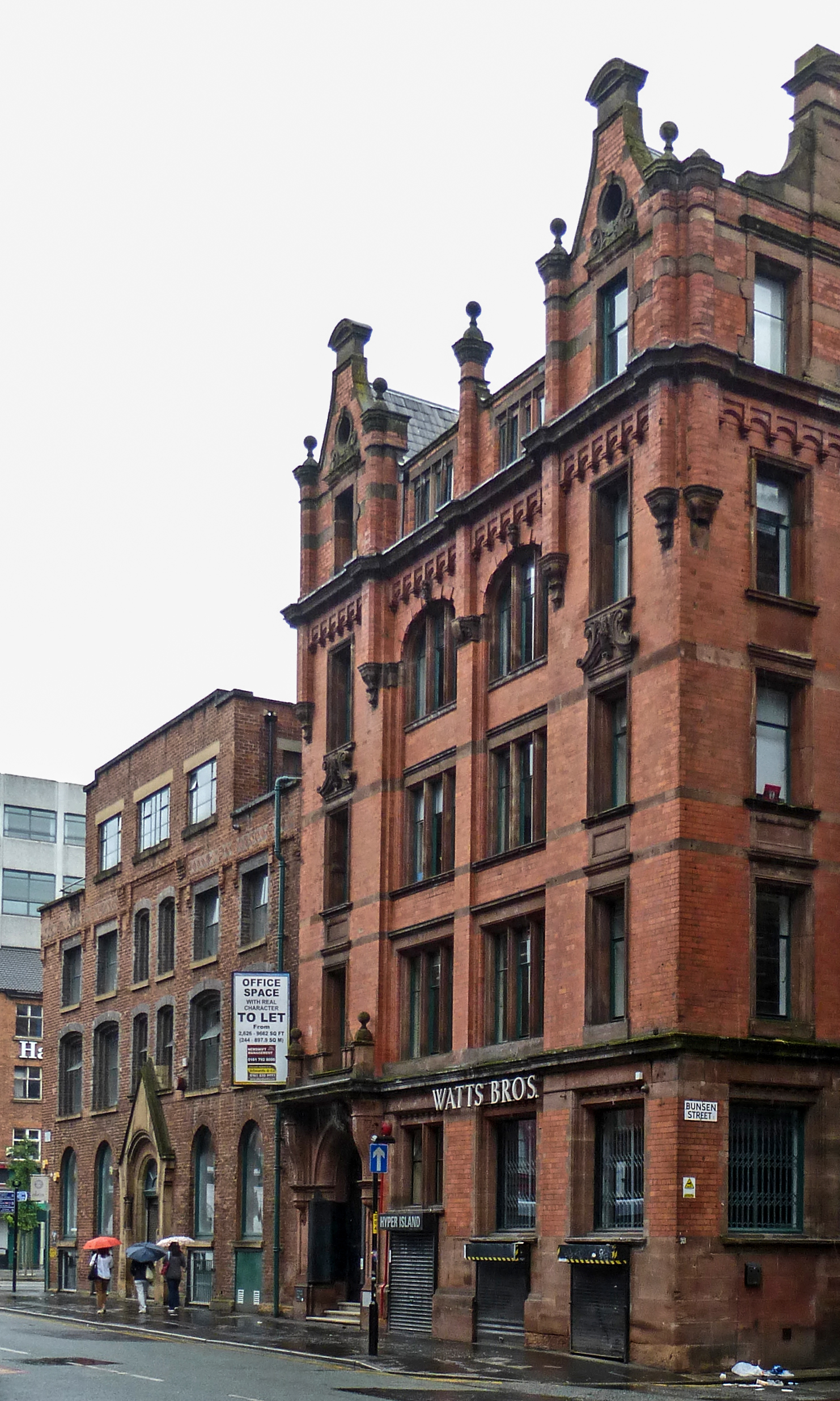 some very tall brick buildings on the street